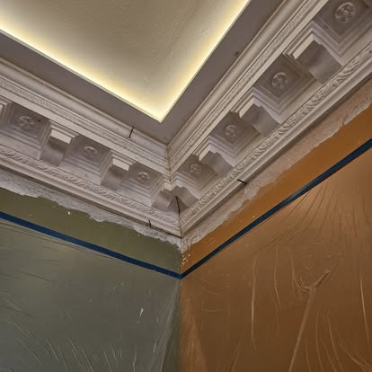 Close-up of ornate cornice with ceiling lighting